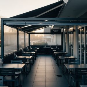 Mblinds Cafe Screens NZ protecting an outdoor dining area